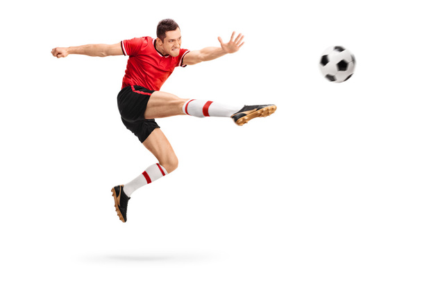 Football player kicking a ball - Foto, Imagen