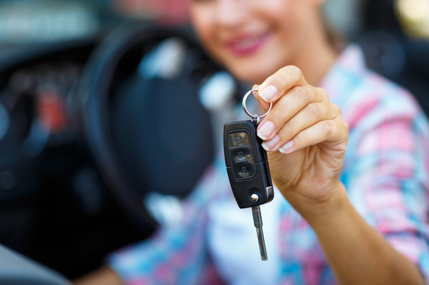 Woman standing near a convertible with keys in hand - concept of - Photo, Image