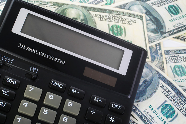 calculator on hundred dollar banknotes - 写真・画像