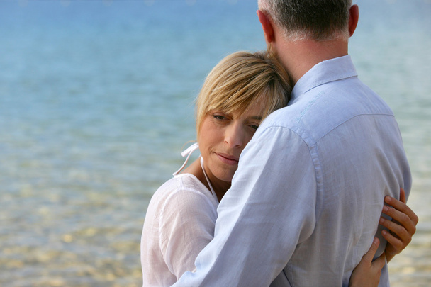 Blonde woman hugging her husband - Foto, imagen