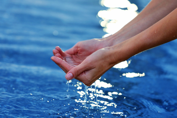 Female hands touching sea water - Φωτογραφία, εικόνα