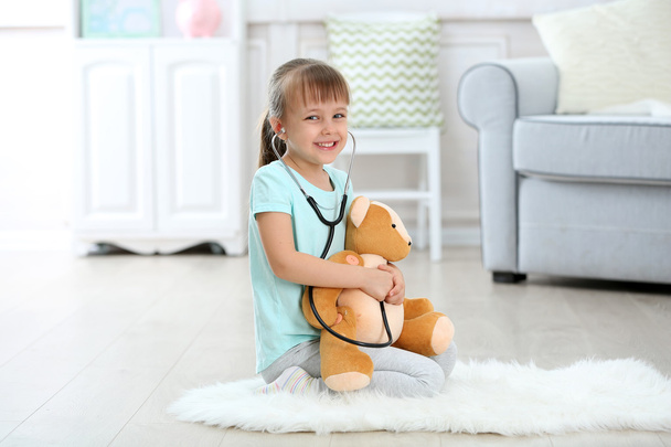 girl with stethoscope and bear - Photo, Image