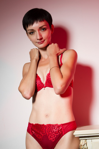 The girl in the red underwear. Studio portrait - Photo, Image