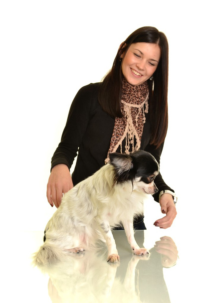 Girl posing in studio with her small dog - Foto, afbeelding