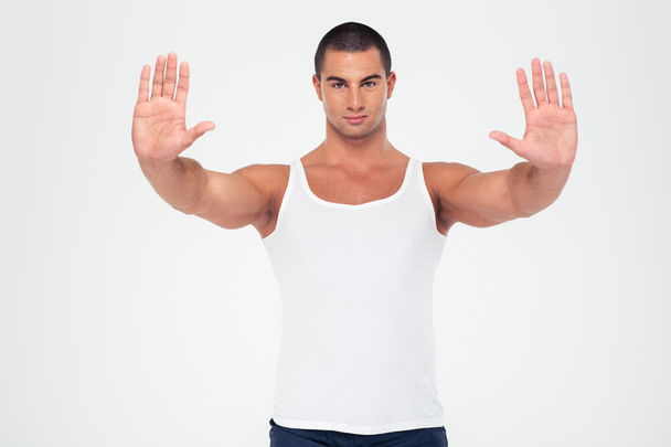 Strong man showing stop gesture with palms - Zdjęcie, obraz