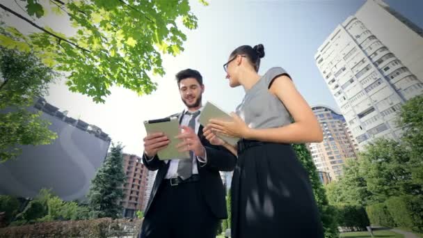 成功したビジネスマンはタブレットで走り、お互いを楽しそうに見つめ合う - 映像、動画