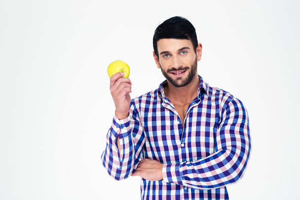 Portrait of a happy athletic man holding apple - Photo, Image