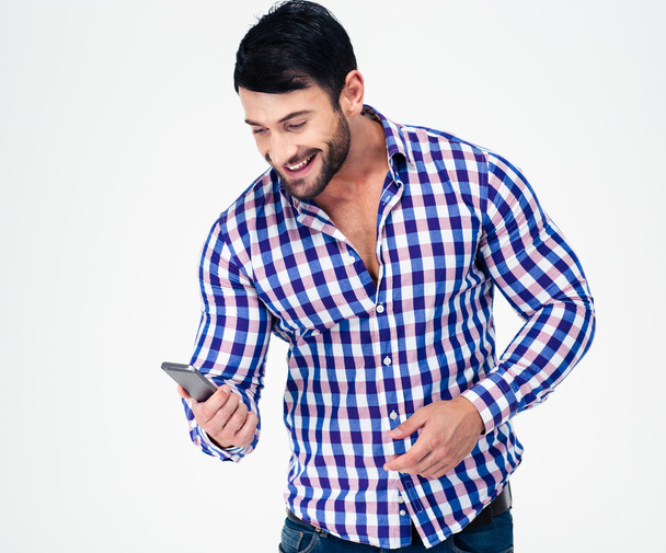 Portrait of a smiling casual man using smartphone - Fotó, kép