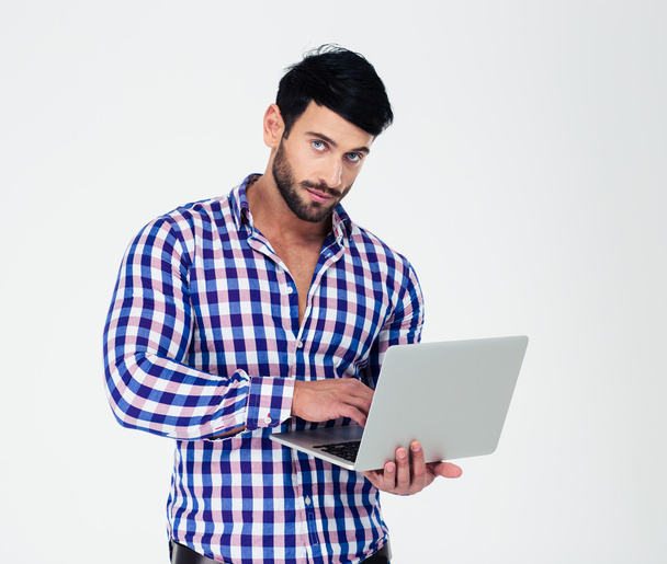 Portrait of a handsome man using laptop computer - Foto, imagen