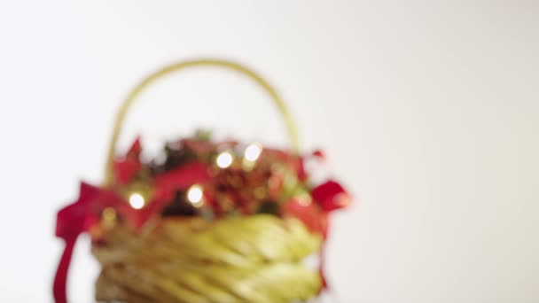 Christmas basket with berries, leaves, pine cones and garland - Materiaali, video