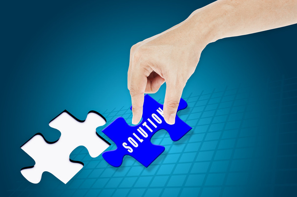 Hand inserting missing solution jigsaw puzzle - Photo, Image