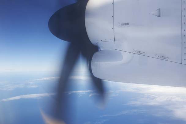 Aeroplane flying over the ocean and turbine detail in movement - Photo, Image