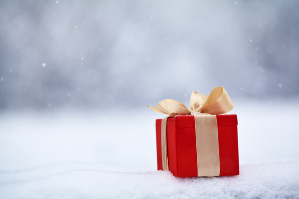 gift box in the snow outdoors - Fotó, kép