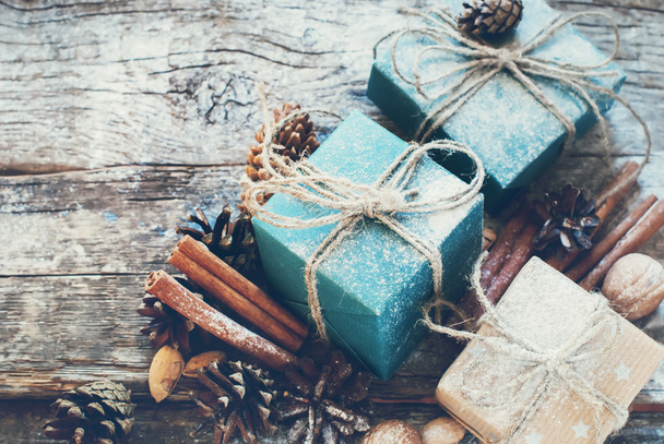 Holiday Boxes with Linen Cord, Cinnamon, Pine cones, Nuts. Toned - Фото, изображение