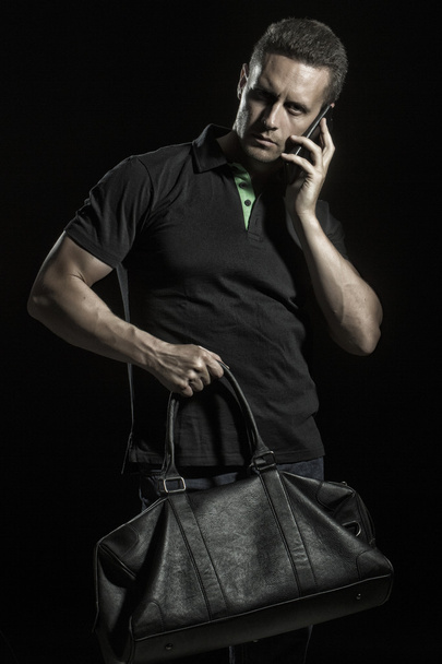 Strong muscular man with bag - Foto, Imagen