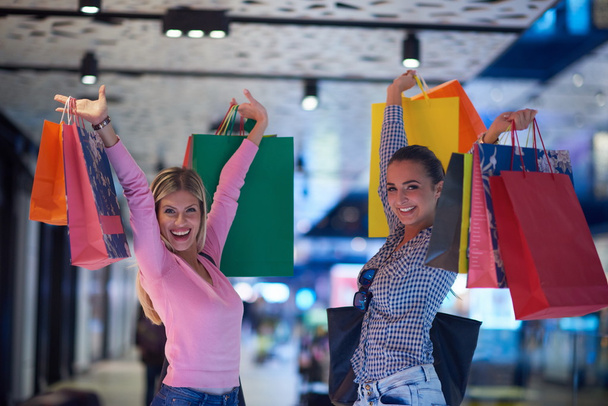 happy young girls in shopping mall - Photo, Image