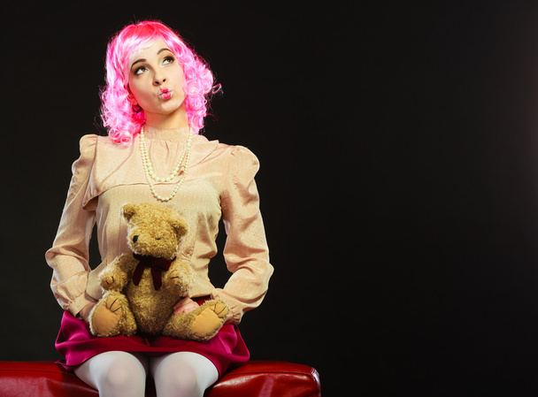 childlike woman and teddy bear sitting on couch - Foto, Imagem