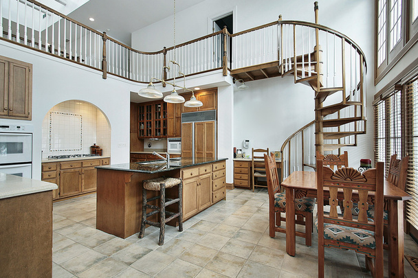Large kitchen with spiral stairway to second floor - Photo, Image
