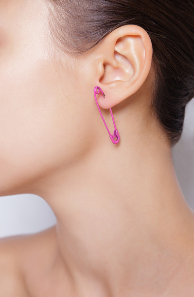 Close up image of female ear with earring - 写真・画像