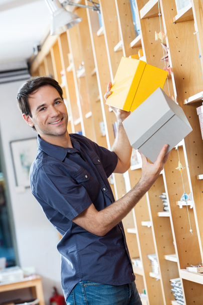 Smiling Male Customer Removing Cardboard Boxes From Shelf - Fotoğraf, Görsel