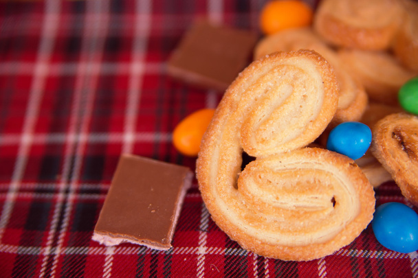 Puff pastry cookies, chocolate and colored pills - Photo, Image