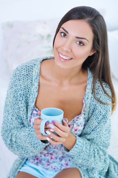 Portrait of a smiling beautiful woman with morning coffee - Fotó, kép