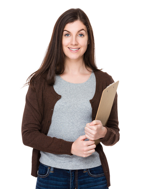 Woman holds clipboard in hands - Fotoğraf, Görsel