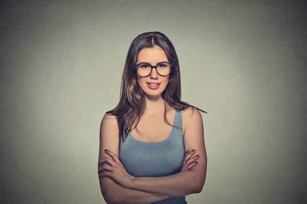 smiling young woman in black glasses with crossed arms - Foto, afbeelding