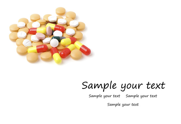 Colored pills and tablets on a white background - 写真・画像
