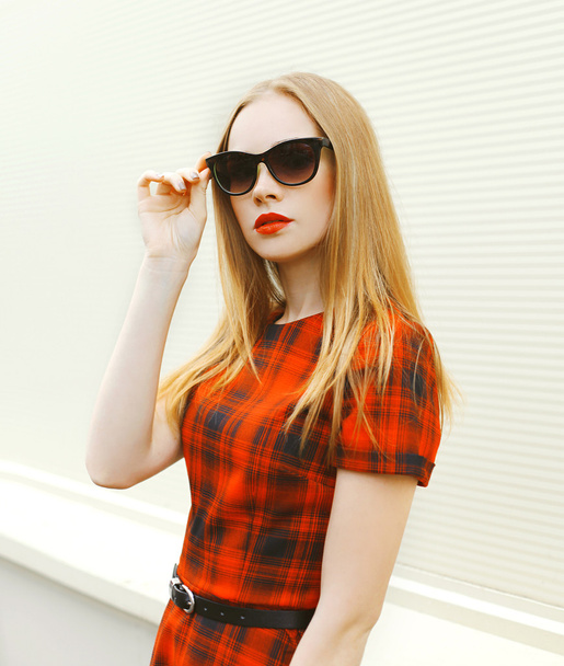 Beautiful blonde woman in sunglasses and red dress - Фото, зображення