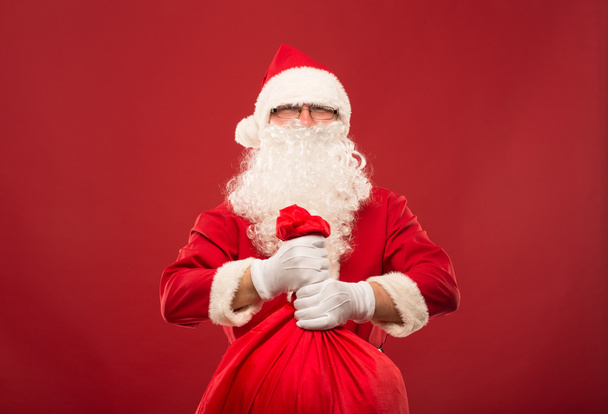 Portrait of happy Santa Claus with a huge sack - Фото, зображення