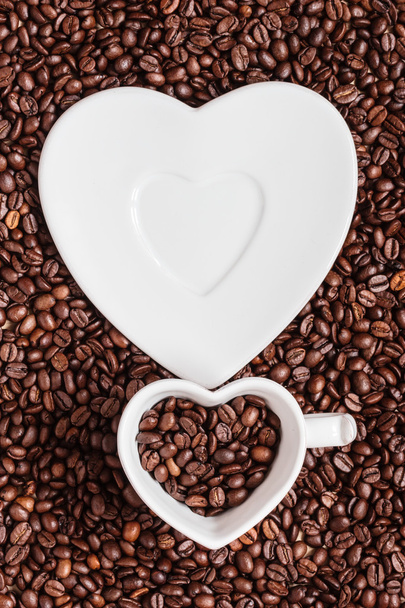 cup and saucer on coffee beans background - Photo, Image