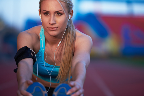sporty woman on athletic race track - Фото, изображение