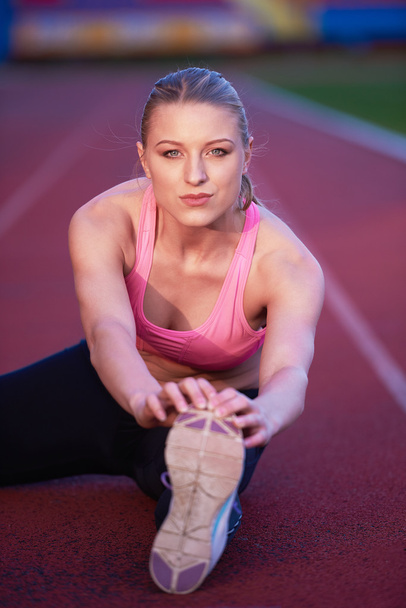 sporty woman on athletic race track - Foto, Imagen