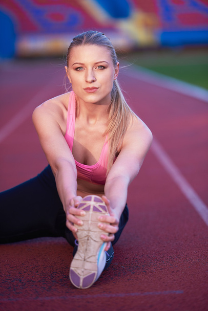 sporty woman on athletic race track - Photo, Image