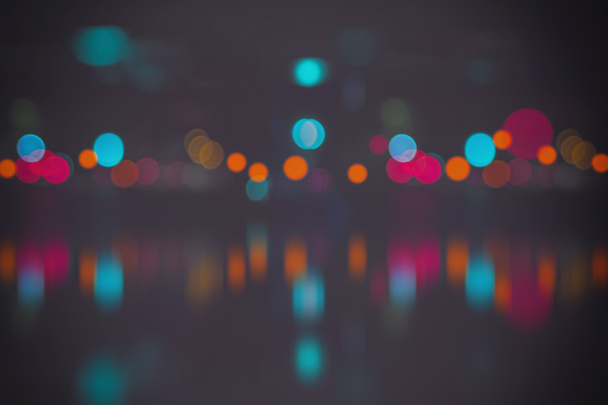 Blurred city lights with bokeh on water - Photo, Image