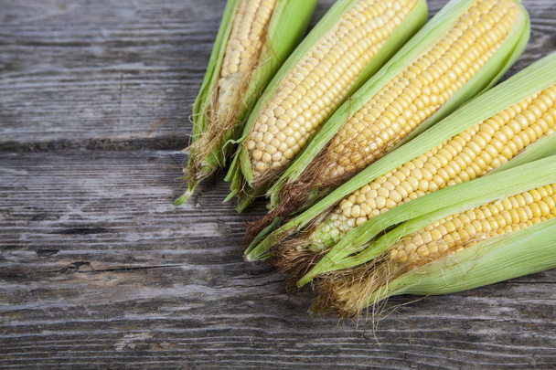 Corn on a wooden table - Фото, зображення