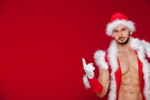 Sexy muscular man in santa uniform. Christmas New Year - 写真・画像