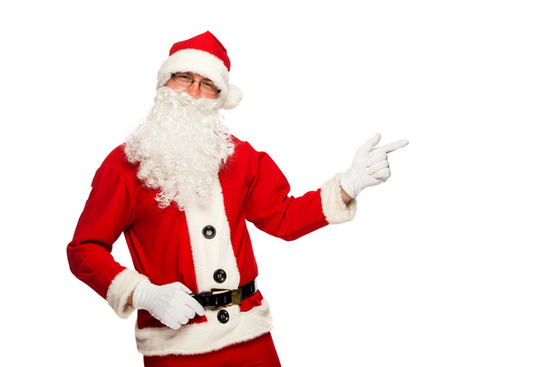 Santa Claus pointing sign with smile, isolated on white background - 写真・画像