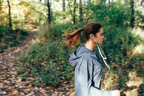 Runner woman jogging in autumn park - Photo, image