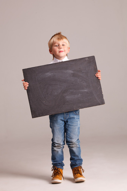 Kid holding a black board - Foto, immagini