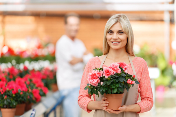 Professional florist selling flowers - Фото, изображение