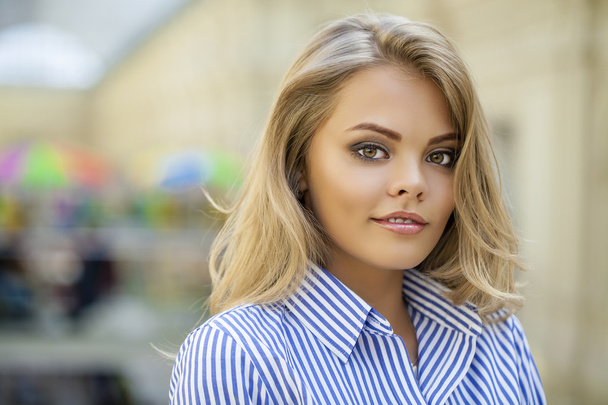 Portrait of a beautiful blonde in a blue striped shirt - Fotoğraf, Görsel