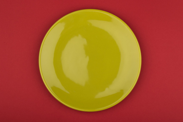 green plate on red background - Photo, Image