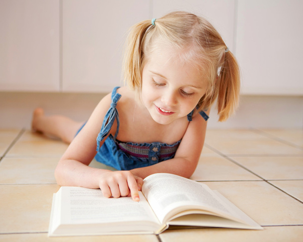 A little four year old girl reading - Photo, Image