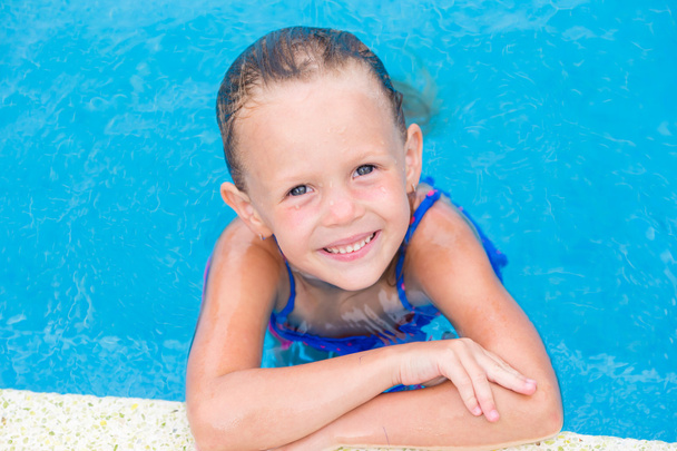 Closeup little beautiful girl in outdoor swimming pool - Foto, imagen