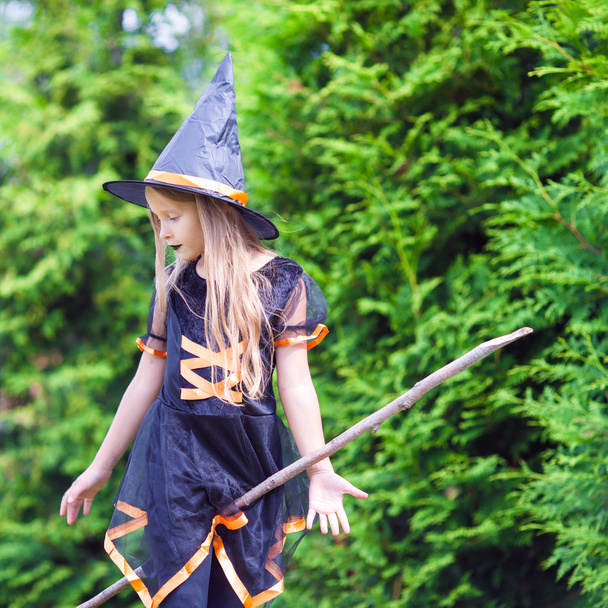 Little girl with broom wearing witch costume on Halloween. Trick or treat. - Photo, Image