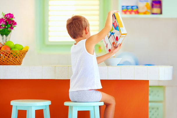 unaided little boy preparing breakfast in the morning at home - Foto, imagen