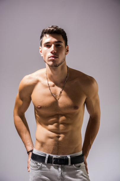 Handsome shirtless athletic young man on white - Foto, Bild