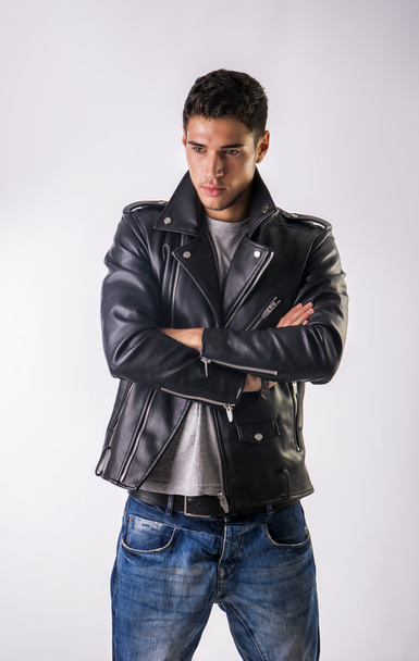 Handsome young man wearing leather jacket, t-shirt and jeans - Photo, Image